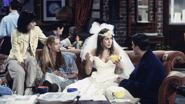 Courteney Cox as Monica Geller, Lisa Kudrow as Phoebe Buffay, Jennifer Aniston as Rachel Green, and David Schwimmer as Ross Geller in Season 1, Episode 1 of "Friends"