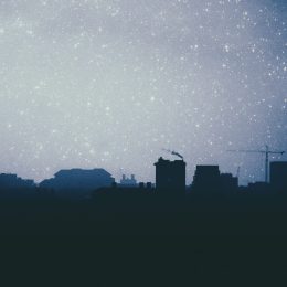 photo of full moon in sagittarius over city skyline