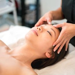 Asian woman getting a face massage at the spa