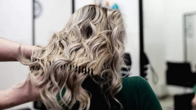 woman at a salon with mushroom blonde hair dye