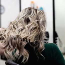 woman at a salon with mushroom blonde hair dye