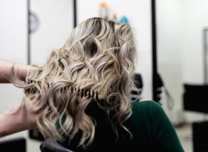 woman at a salon with mushroom blonde hair dye
