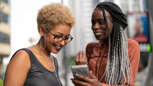 Friends looking at smartphone