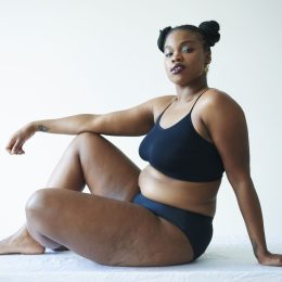 confident curvy woman sitting and looking to camera