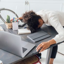 Woman falling asleep at her laptop