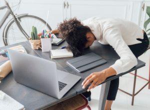 Woman falling asleep at her laptop