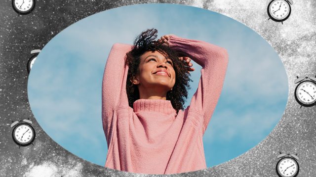 Woman smiling up at the blue sky