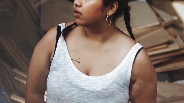 Plus-size woman of color looking into the distance