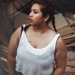 Plus-size woman of color looking into the distance