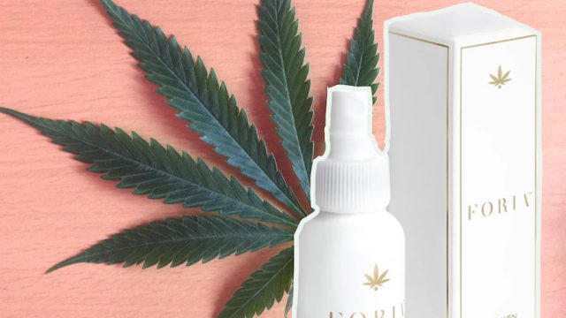 Weed lube bottles positioned in front of weed leaf