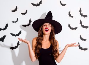 woman dressed as a witch with bats
