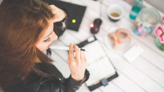 woman at desk saving money, No-Spend November