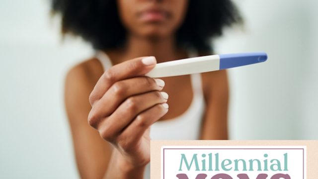 Woman looking at a pregnancy test