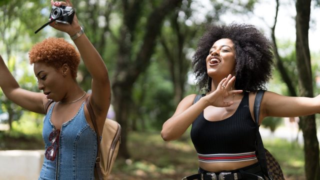 two happy women dancing