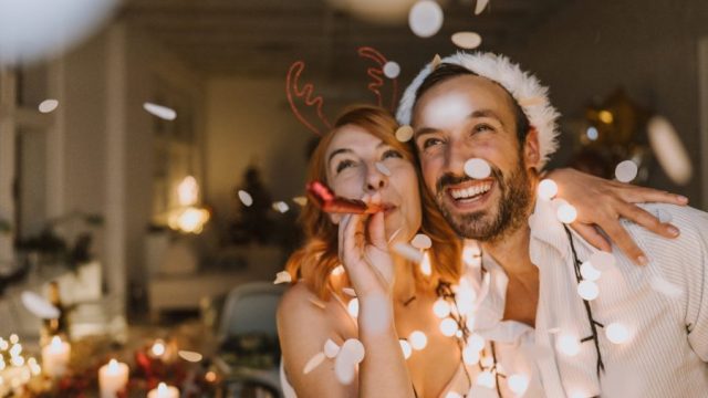 young couple celebrating holidays, interfaith couple hanukkah and christmas