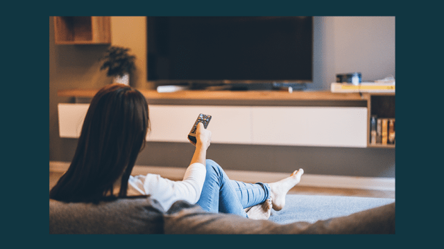 Woman watching tv at home