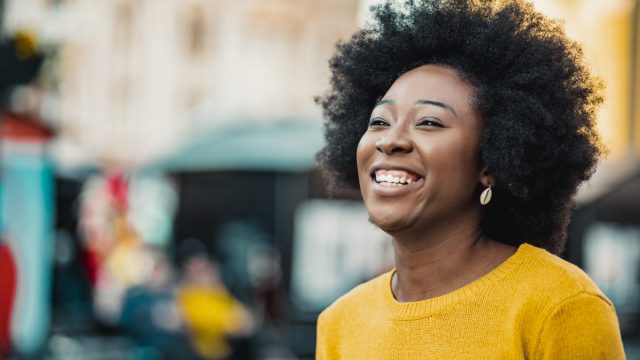sun-damage-on-dark-skin-tones, dark-skin-woman-smiling