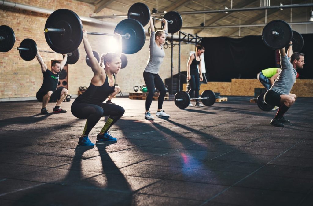 People at Gym Lifting Weights