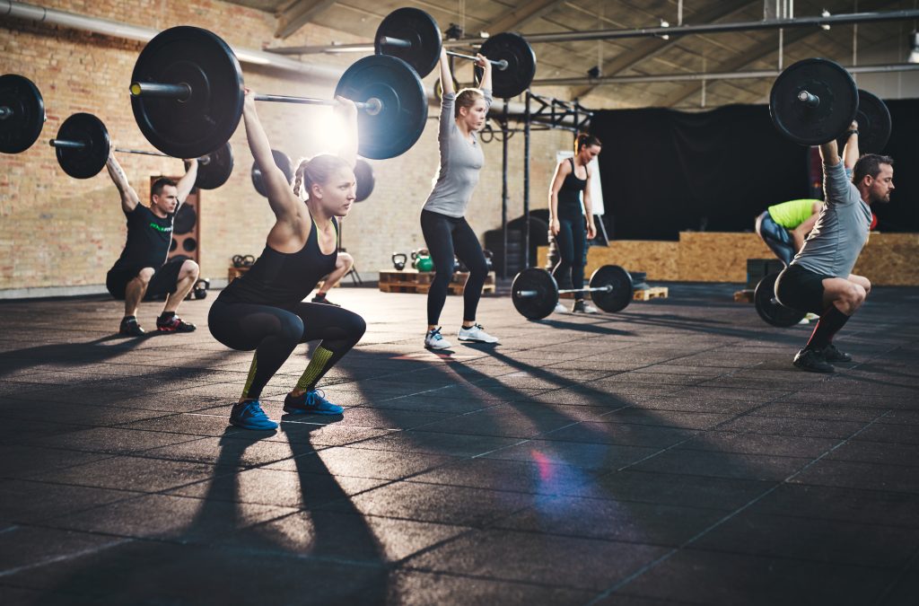 People at Gym Lifting Weights