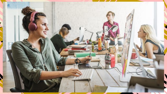 woman at work on computer with headphones