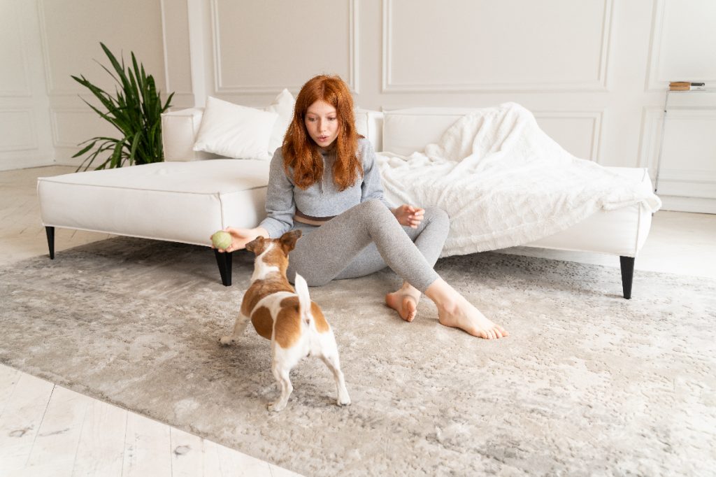Woman playing with dog