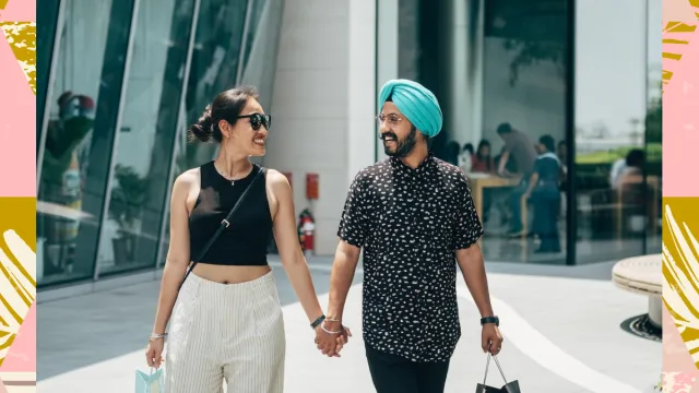 couple walking holding hands smiling