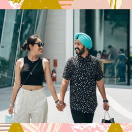 couple walking holding hands smiling