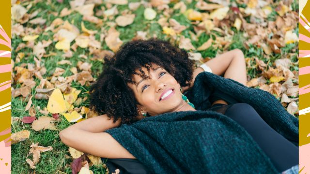 happy woman smiling in the fall leaves