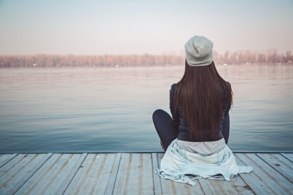 Girl sitting on pier