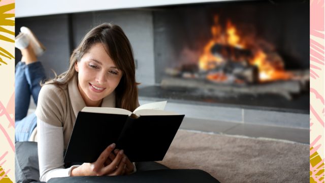 Woman reading by fire