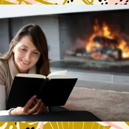 Woman reading by fire