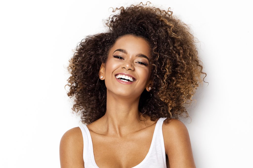 woman smiling with curly hair