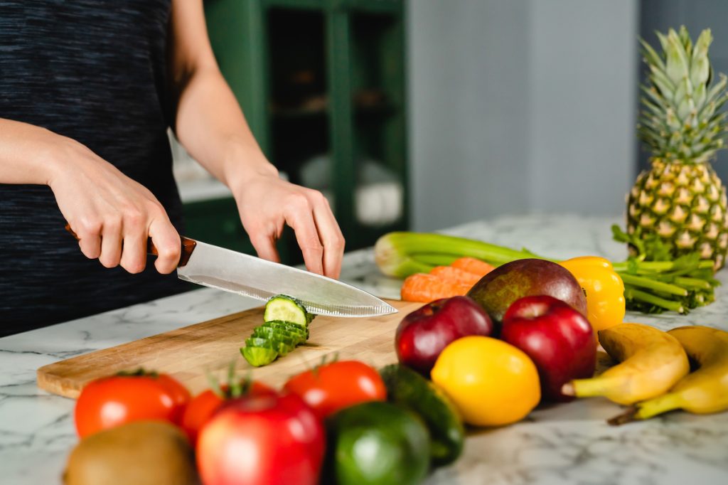 woman chopping vegetables in the kitchen