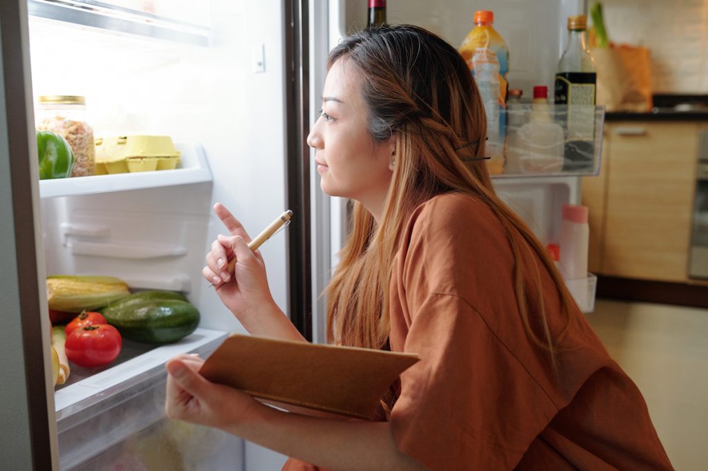 woman looking in fridge
