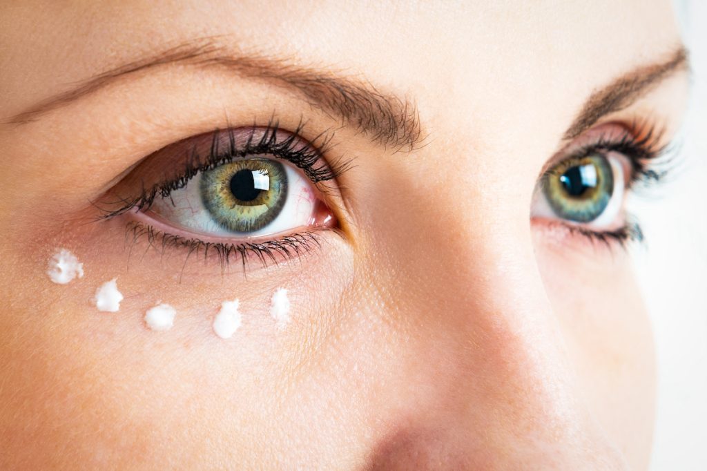 woman applying eye cream