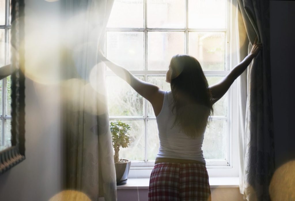 woman looking out window
