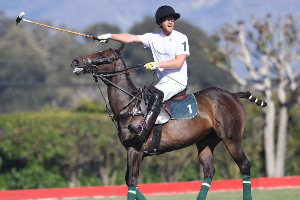 Prince Harry playing polo on a horse