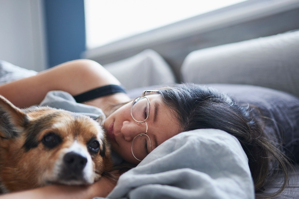 WOMAN IN BED WITH PET